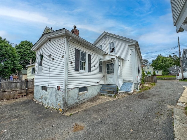 233 Grove St, Woonsocket, RI 02895 - view of front of house with entry steps and a chimney