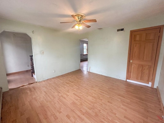233 Grove St, Woonsocket, RI 02895 - unfurnished room featuring light wood-type flooring, a ceiling fan, and arched walkways