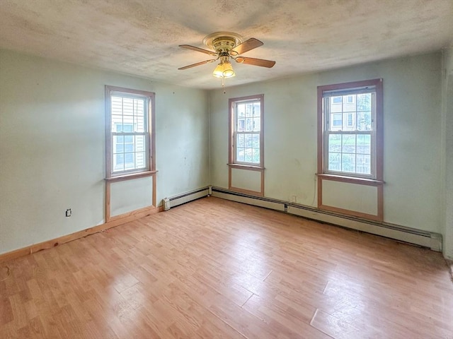 233 Grove St, Woonsocket, RI 02895 - empty room with wood finished floors, plenty of natural light, ceiling fan, and a textured ceiling