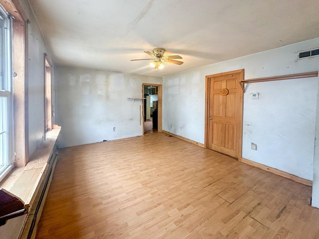233 Grove St, Woonsocket, RI 02895 - empty room featuring a ceiling fan, light wood-type flooring, and healthy amount of natural light