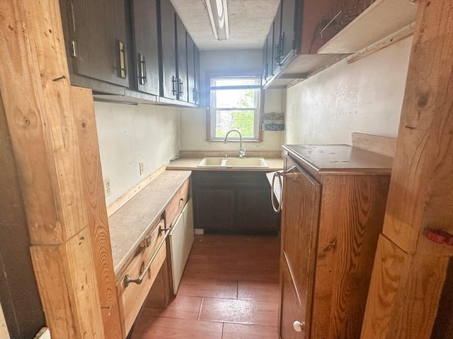 233 Grove St, Woonsocket, RI 02895 - kitchen featuring a sink, light countertops, and wood finished floors