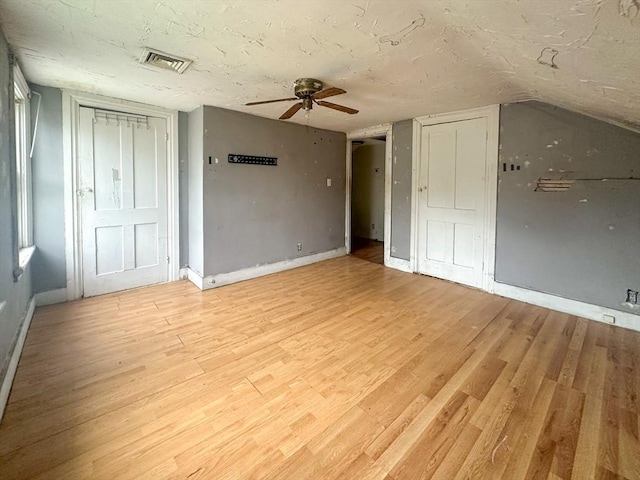 233 Grove St, Woonsocket, RI 02895 - unfurnished bedroom with baseboards, light wood-style floors, and a ceiling fan