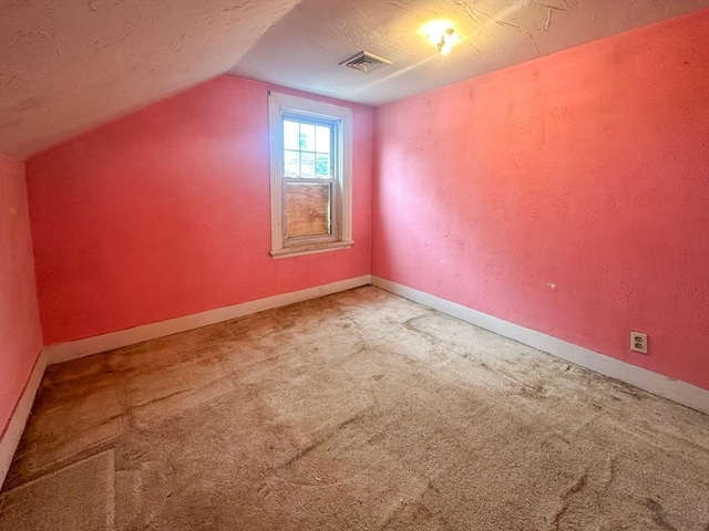 233 Grove St, Woonsocket, RI 02895 - bonus room with vaulted ceiling, carpet floors, and baseboards