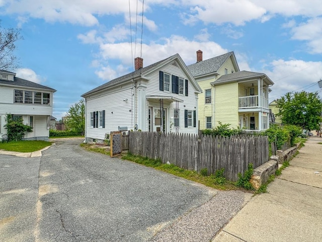 233 Grove St, Woonsocket, RI 02895 - view of front facade featuring a chimney