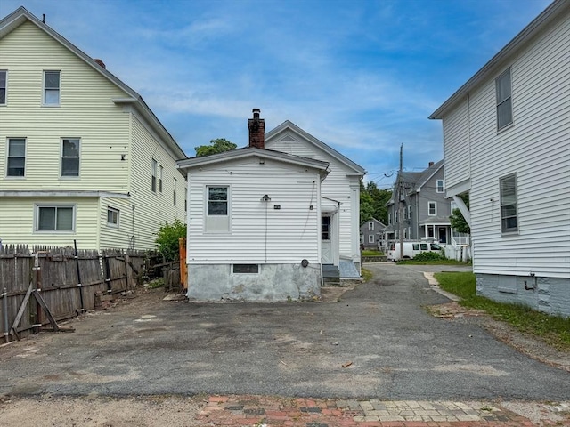 233 Grove St, Woonsocket, RI 02895 - back of house with a chimney