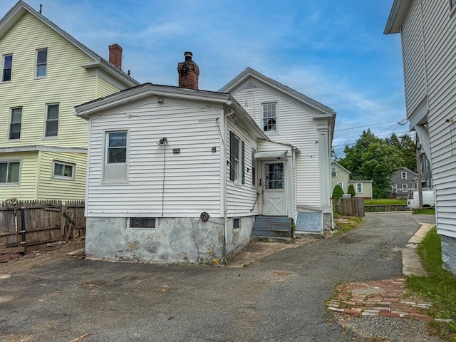233 Grove St, Woonsocket, RI 02895 - back of house featuring entry steps and a chimney