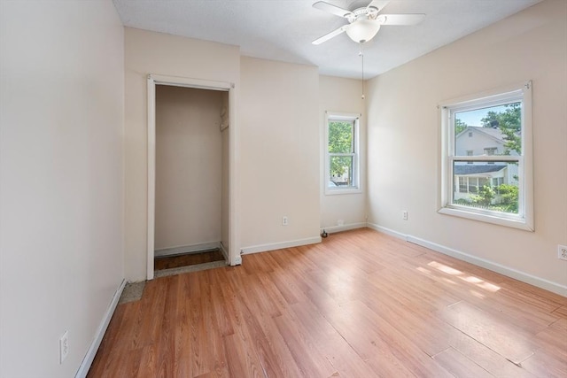 72 Hall St, Springfield, MA 01108 - unfurnished bedroom featuring multiple windows, light wood finished floors, and a ceiling fan