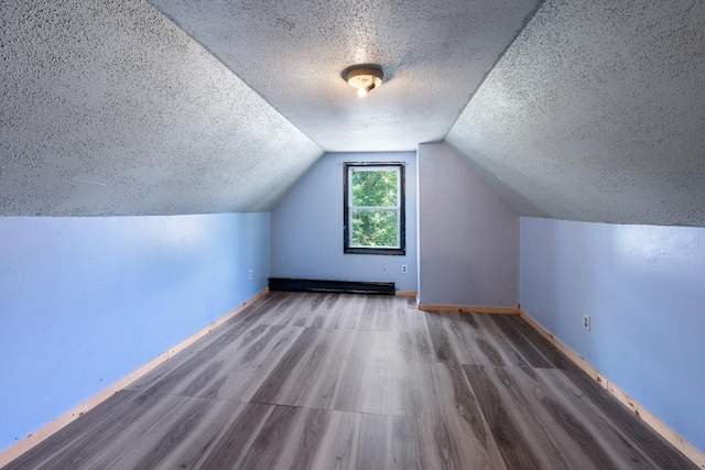 72 Hall St, Springfield, MA 01108 - bonus room featuring a textured ceiling, wood finished floors, and vaulted ceiling
