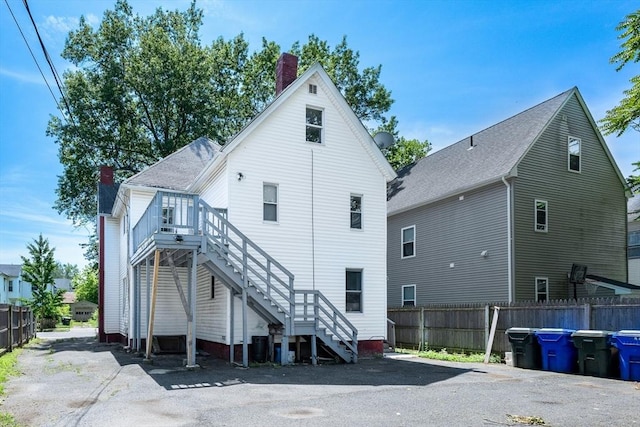 72 Hall St, Springfield, MA 01108 - rear view of property with a chimney, stairway, and a deck