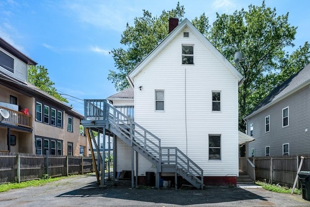 72 Hall St, Springfield, MA 01108 - back of property featuring stairway and a chimney