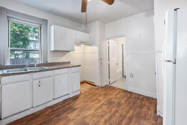 72 Hall St, Springfield, MA 01108 - kitchen with freestanding refrigerator, dark countertops, ceiling fan, dark wood-style floors, and white cabinetry