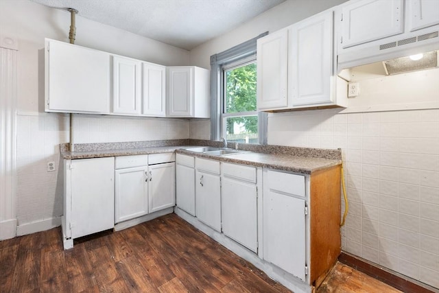 72 Hall St, Springfield, MA 01108 - kitchen featuring tile walls, under cabinet range hood, dark wood finished floors, white cabinetry, and wainscoting