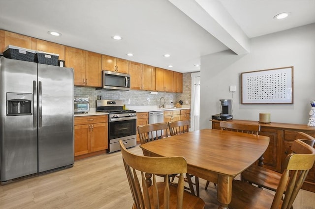 171 Boyce St, Auburn, MA 01501 - kitchen with stainless steel appliances, light countertops, light wood-style flooring, backsplash, and recessed lighting