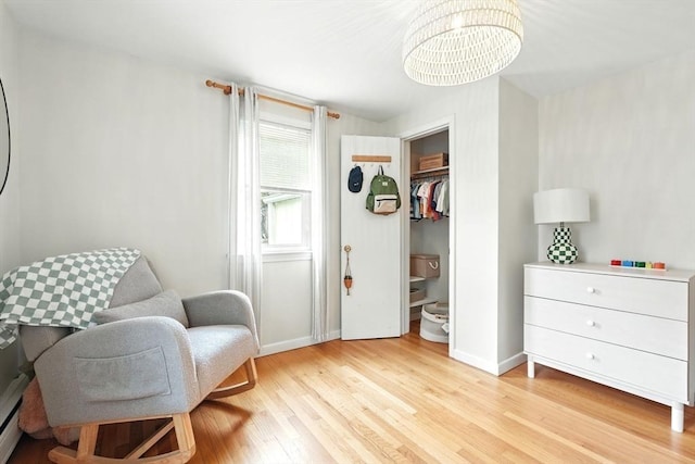 116 Anthony St, Agawam, MA 01001 - sitting room with light wood finished floors, a chandelier, and baseboards