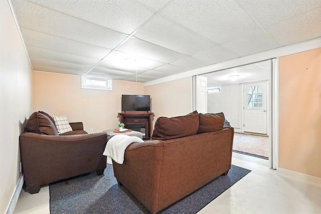 116 Anthony St, Agawam, MA 01001 - living room featuring a paneled ceiling, baseboards, and finished concrete flooring