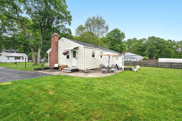 116 Anthony St, Agawam, MA 01001 - back of house with a chimney and view of scattered trees