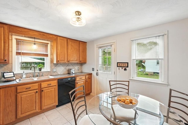 116 Anthony St, Agawam, MA 01001 - kitchen with black dishwasher, a sink, backsplash, brown cabinets, and light countertops