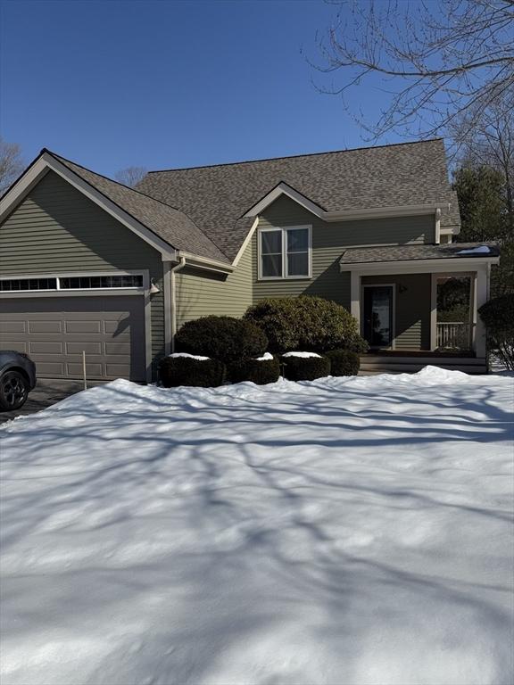 view of front of house featuring an attached garage and a porch