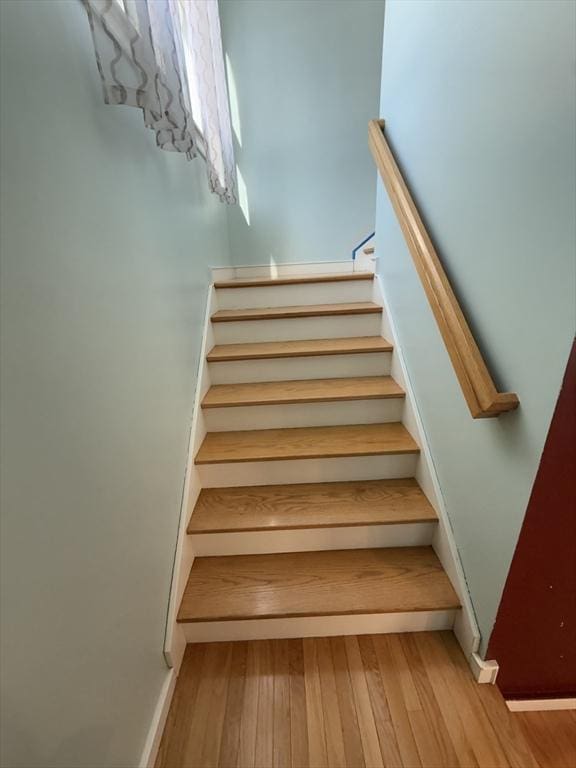 stairs with hardwood / wood-style floors