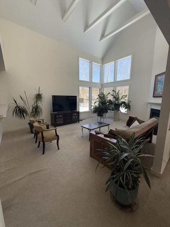 living area featuring a fireplace, high vaulted ceiling, carpet flooring, and beamed ceiling