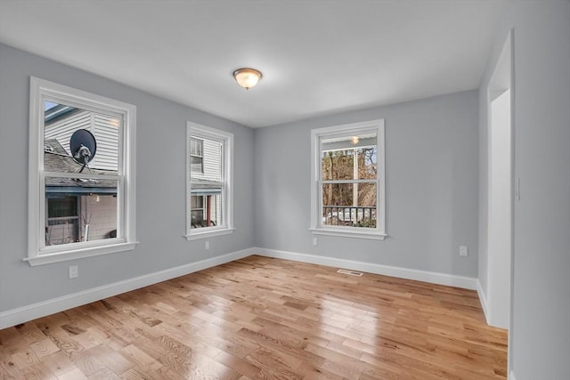 spare room featuring light wood-type flooring