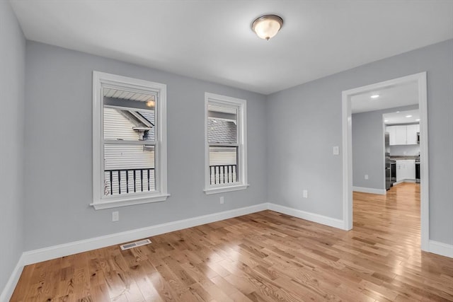 spare room featuring light hardwood / wood-style flooring