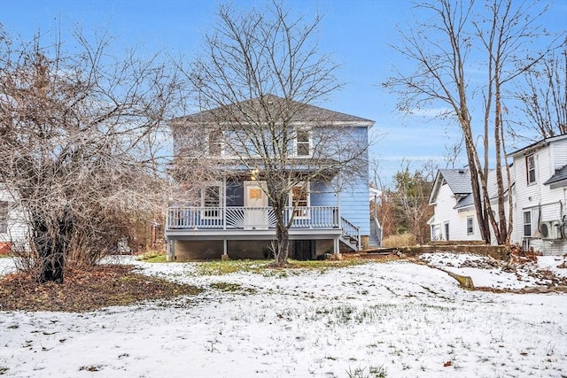 snow covered property with a porch