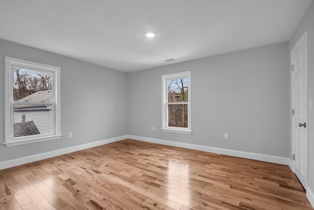 empty room with light hardwood / wood-style flooring