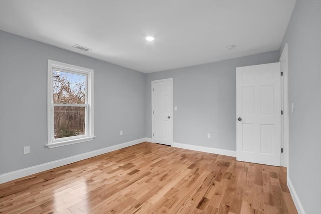 spare room with light hardwood / wood-style flooring