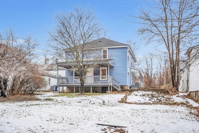 snow covered property featuring covered porch