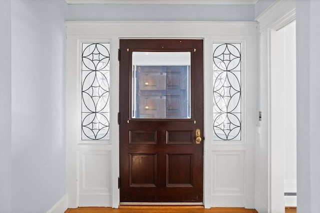 entrance foyer with hardwood / wood-style flooring and a baseboard radiator