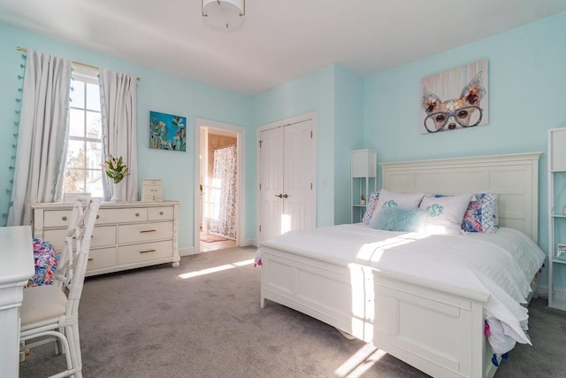 bedroom with dark carpet and a closet