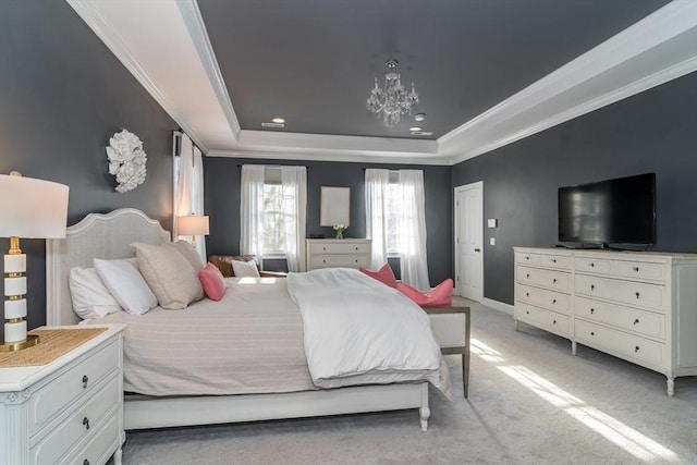 carpeted bedroom featuring crown molding, a tray ceiling, and a chandelier