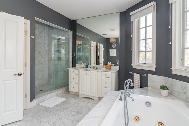 bathroom featuring vanity, separate shower and tub, and a healthy amount of sunlight