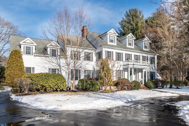 cape cod-style house with a balcony