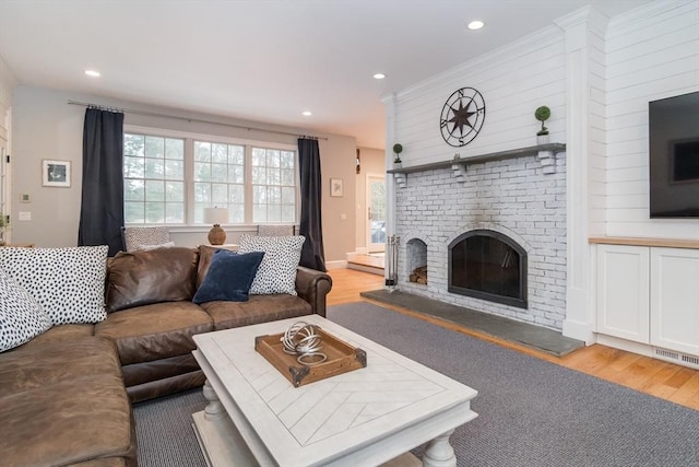 living room featuring a fireplace and light hardwood / wood-style floors