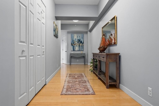 hallway with hardwood / wood-style flooring