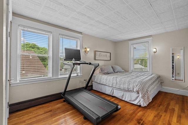 bedroom with wood finished floors and baseboards