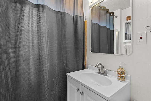 full bathroom featuring vanity, tile walls, and a shower with shower curtain