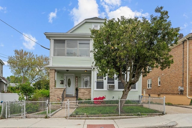 view of front of property featuring a gate, brick siding, and a fenced front yard