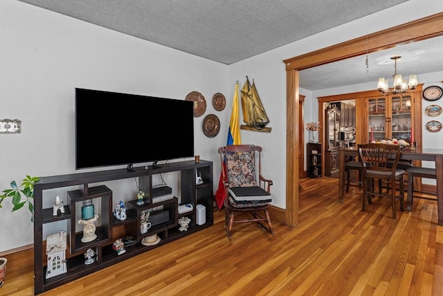living area featuring a chandelier and wood finished floors