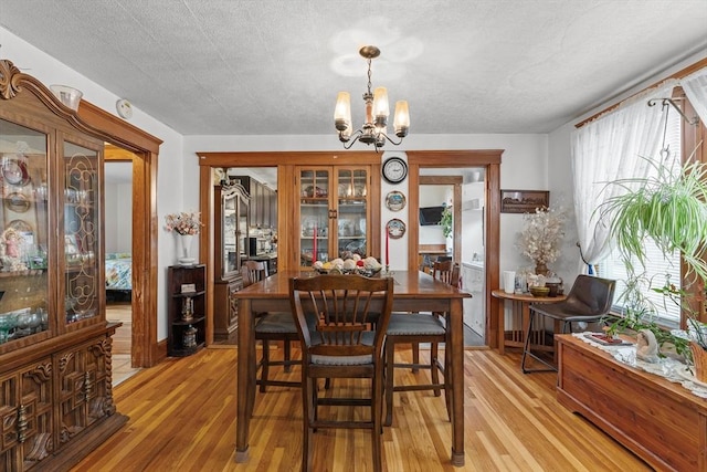 dining room with a chandelier and light wood-style flooring
