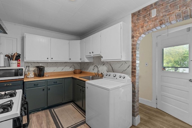 laundry room featuring washer / dryer and light wood-style flooring