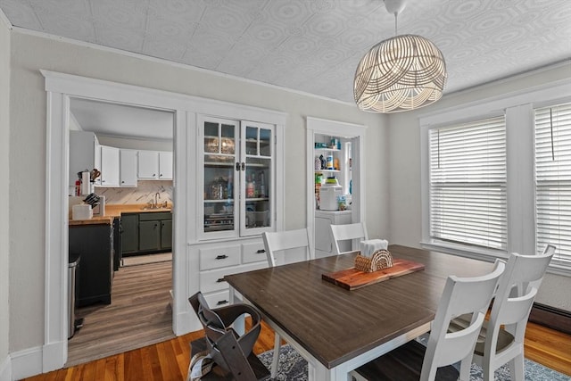 dining room with an ornate ceiling and wood finished floors