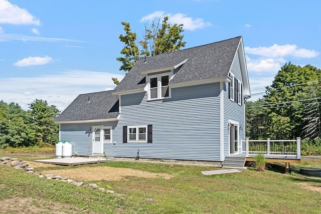 back of property with a yard and a patio area