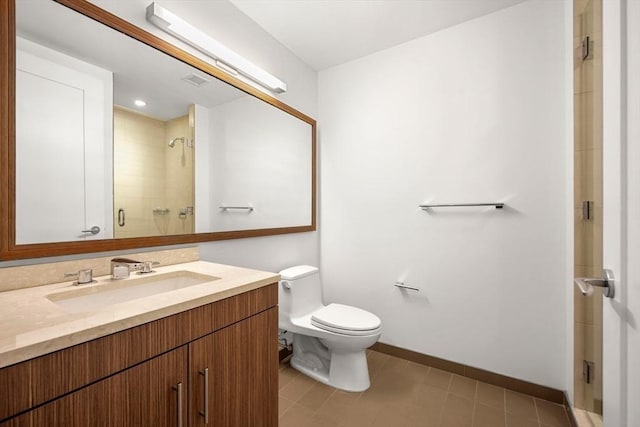 bathroom with vanity, toilet, tile patterned floors, and walk in shower