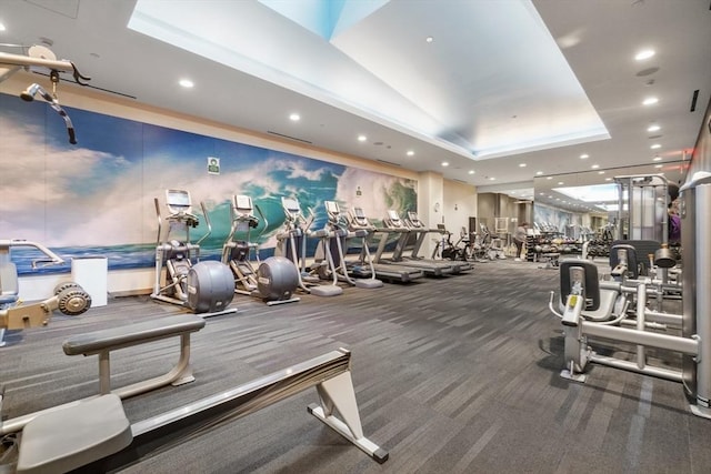 exercise room featuring a tray ceiling