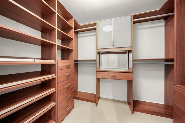 walk in closet featuring light carpet