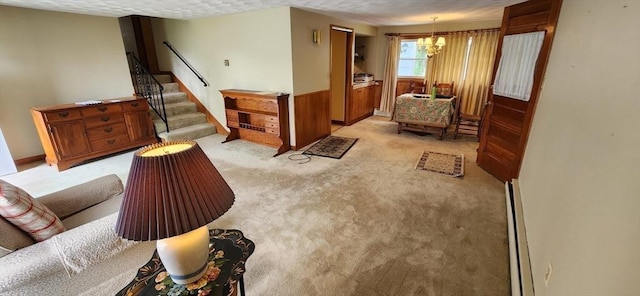 109 Wilder St, Swansea, MA 02777 - living room with a chandelier, stairway, light colored carpet, and baseboard heating