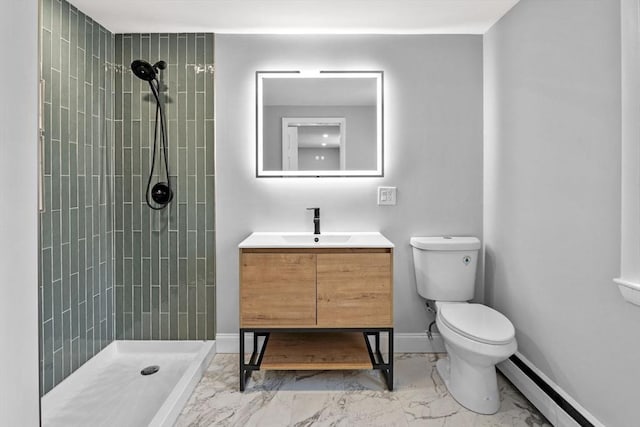 bathroom with tiled shower, toilet, a baseboard heating unit, and vanity